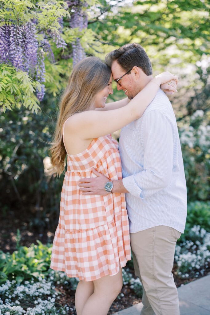 couple forehead to forehead at their dallas arboretum session