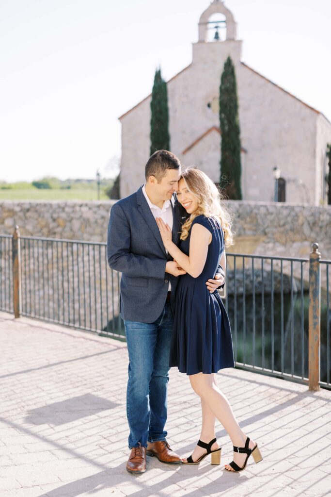 Emily+Michael holding each other during their Adriatica Village Engagement session