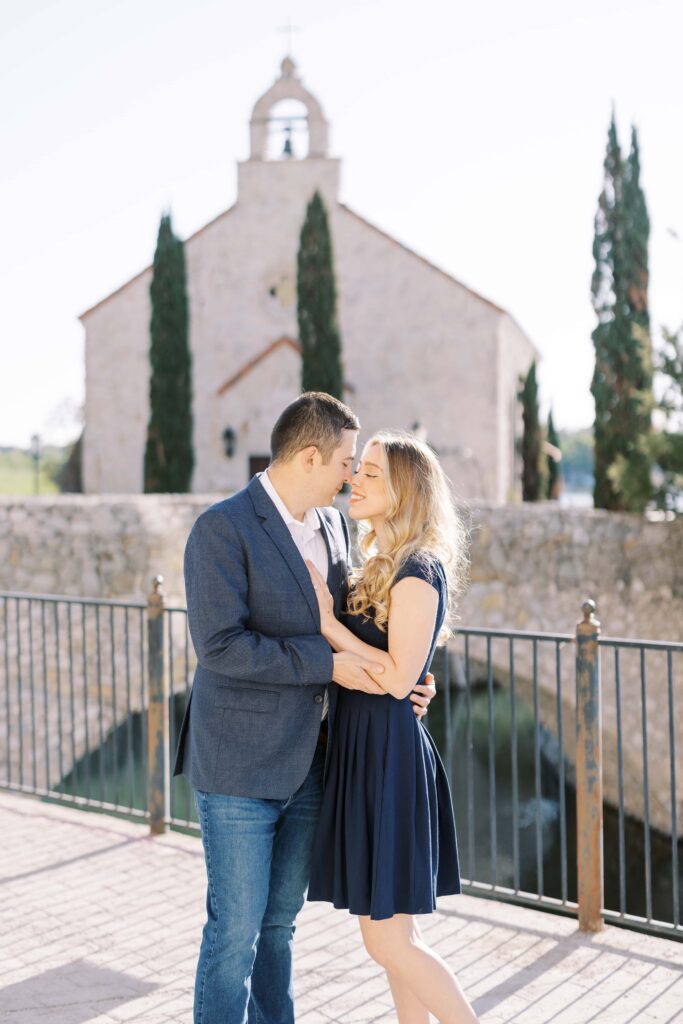 Emily&Michael looking at each other at their Adriatica Village Engagement session