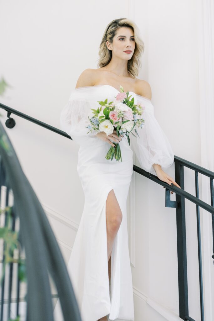 bride in the staircase of the hillside estate looking away 