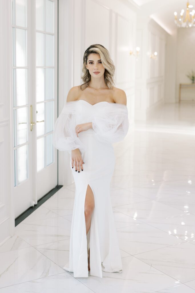 bride standing in a hallway looking at the camera