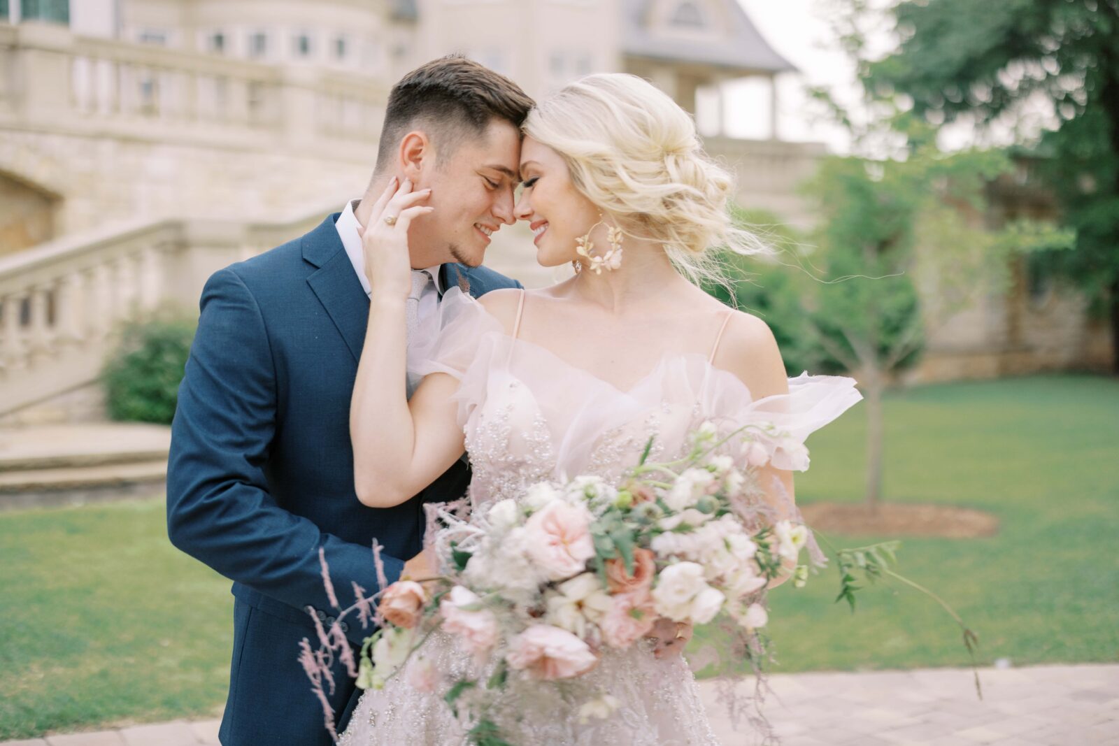 bride and groom standing at the olana staring at each other