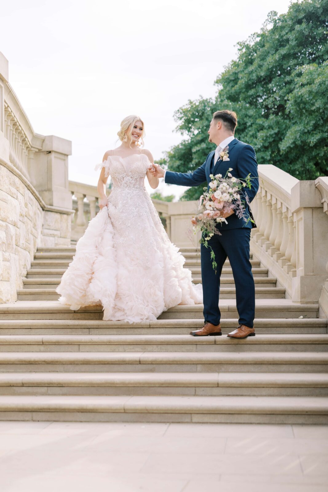 bride and groom coming down the stairs of the Olana 