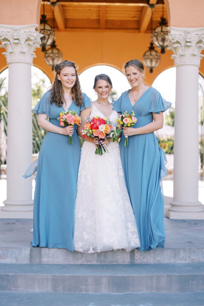 bride with her bridesmaids in th courtyard of the rosewood mansion