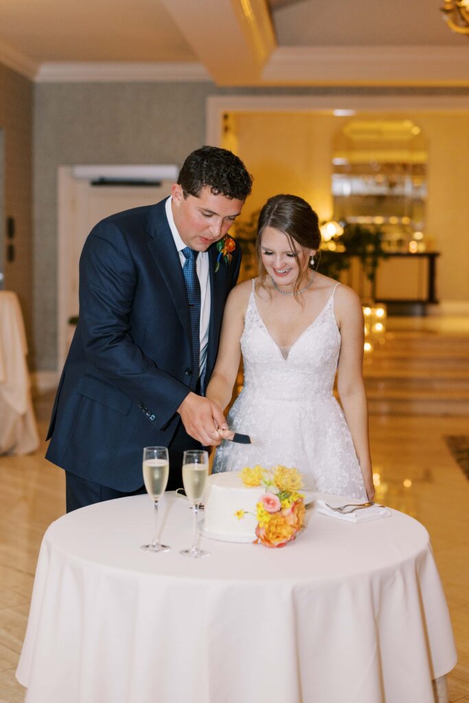 bride and groom eating cake at the rosewood mansion 