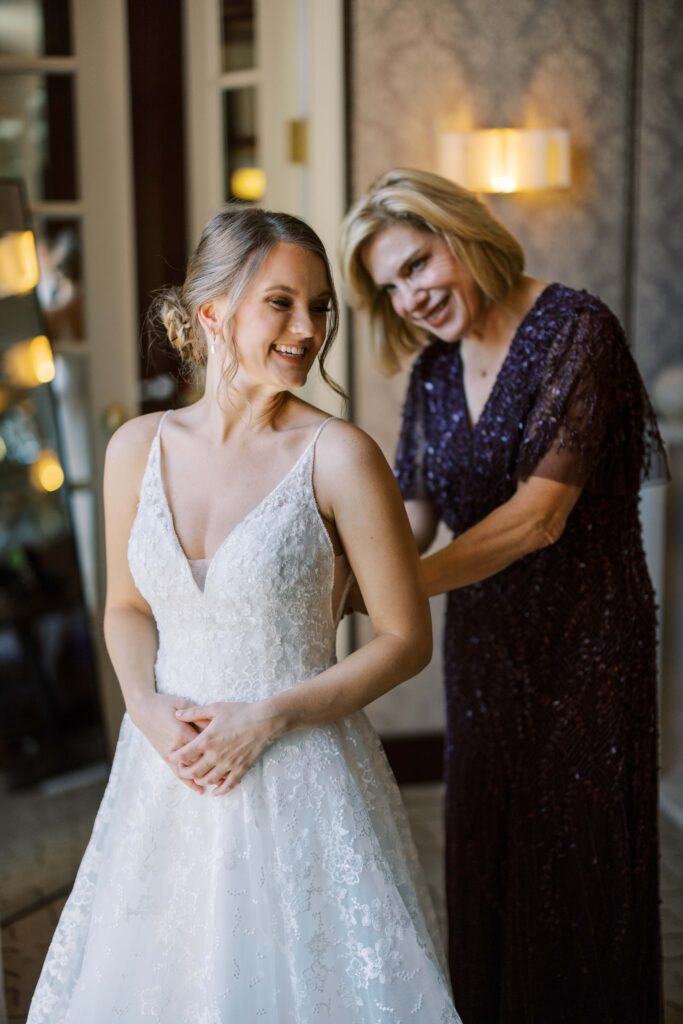 bride smiling back at her mom at the rosewood mansion 
