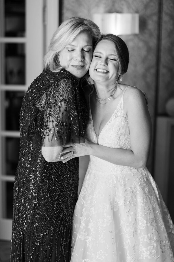 bride hugging her mom in the her rosewood mansion hotel room