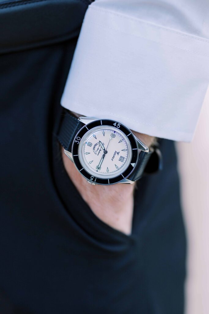 groom showing off his watch for their flippen park engagement photos