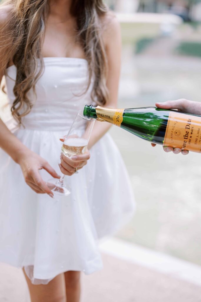 couple drinking champagne during their engagement session