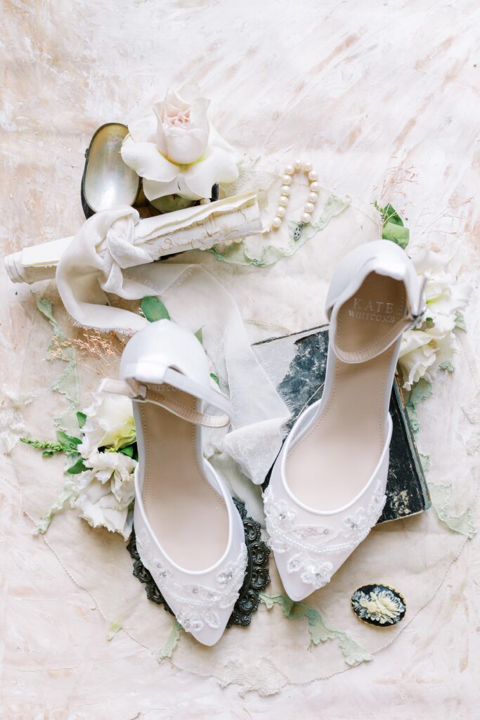 bridal detail flatlay for a france wedding with shoes and pearls