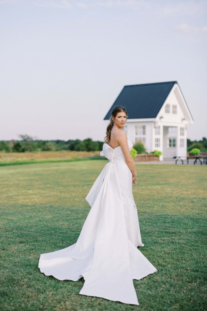 Bride standing in the fields looking at the camera for her Davis and Grey Farms Bridal session 