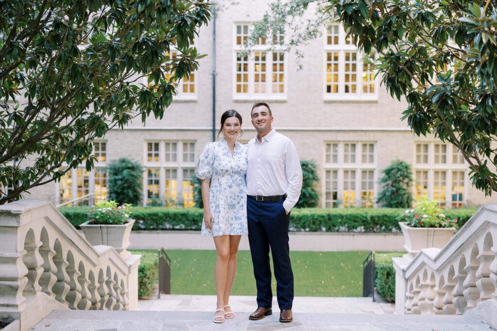 couple standing in the courtyard holding each other during their Engagement Session at HPUMC in Dallas