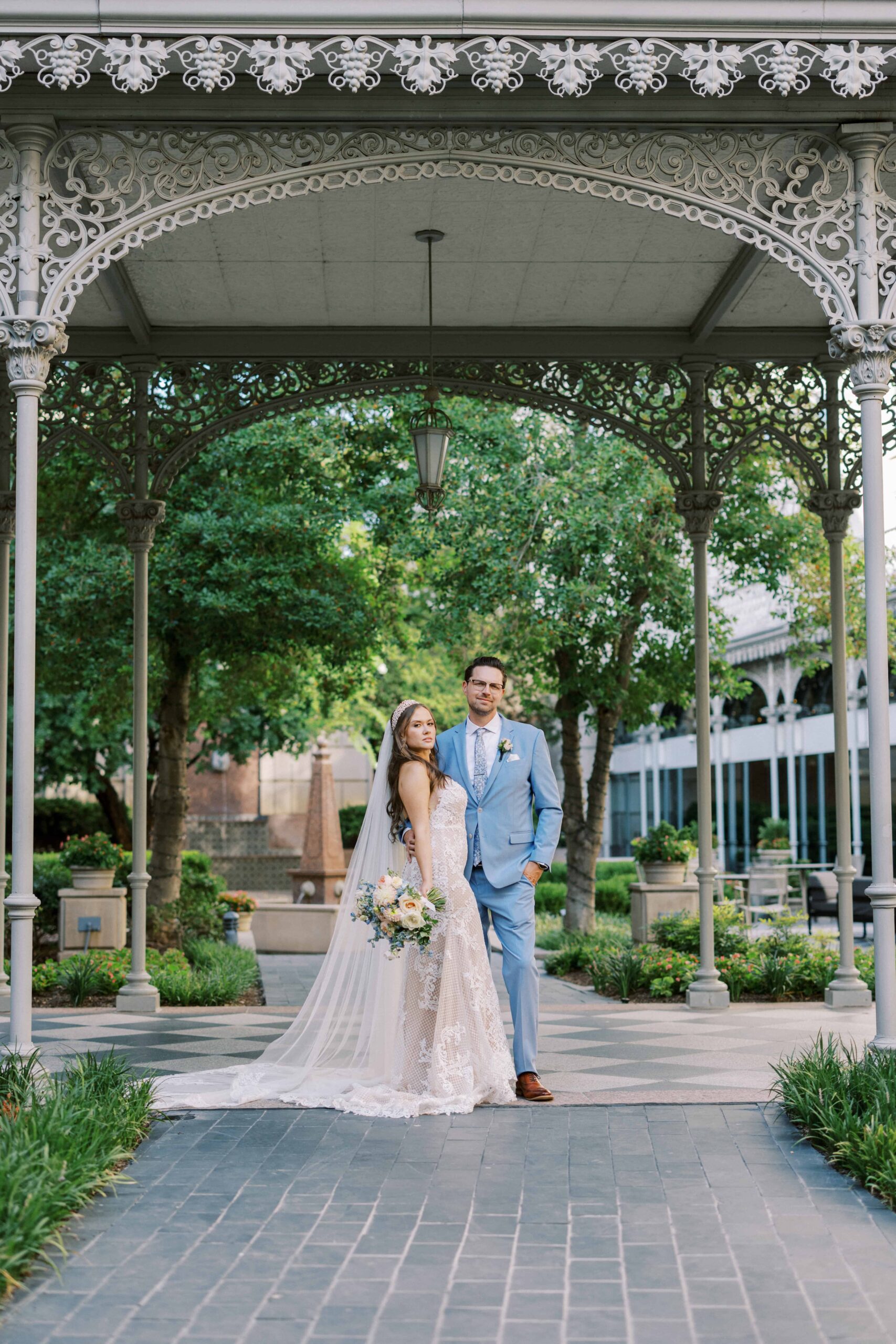 Bride and groom strolling around in the garden during their hotel Crescent Court Wedding