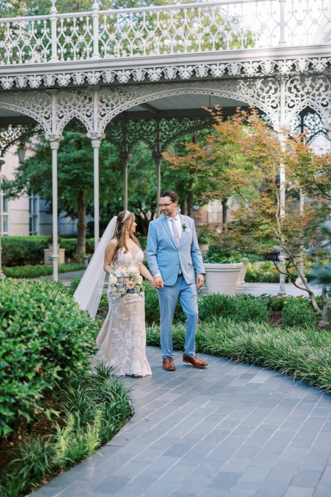 bride and groom walking in the garden during their Hotel Crescent Court wedding