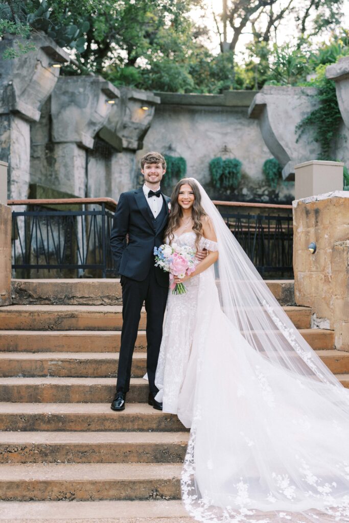 bride and groom standing n the stairs at their Intimate Wedding at Villa Antonia near Austin