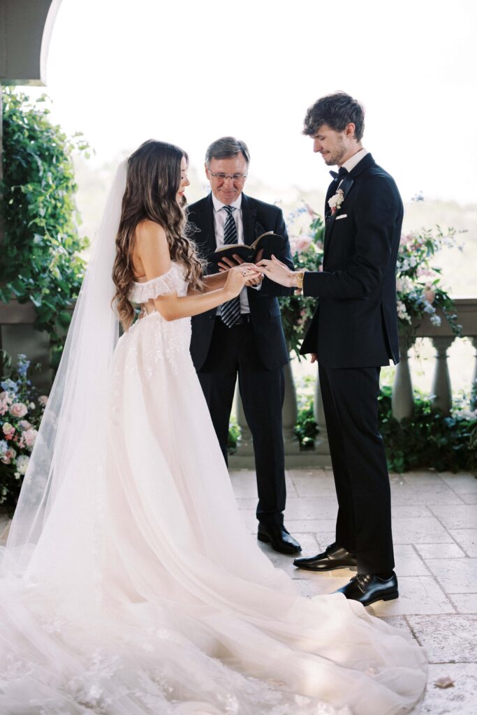 bride and groom standing under the gazebo sharing their vows during their Intimate Wedding at Villa Antonia near Austin