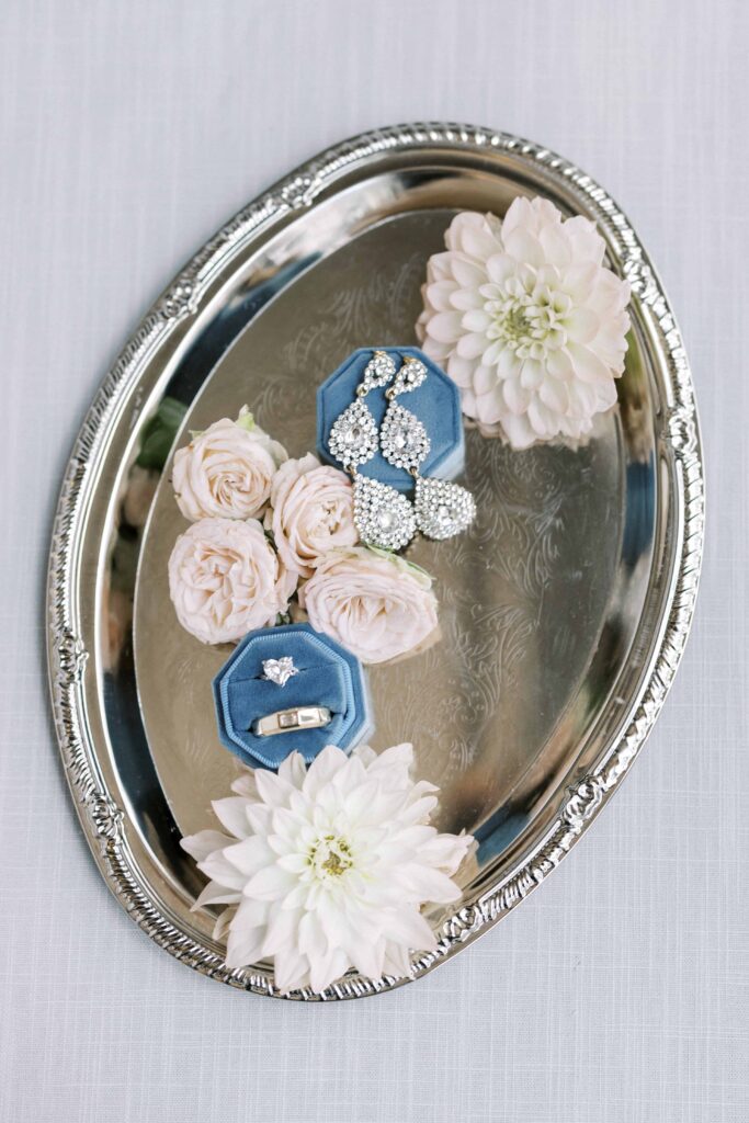 rings and earrings on a silver platter at her Hotel Crescent Court wedding