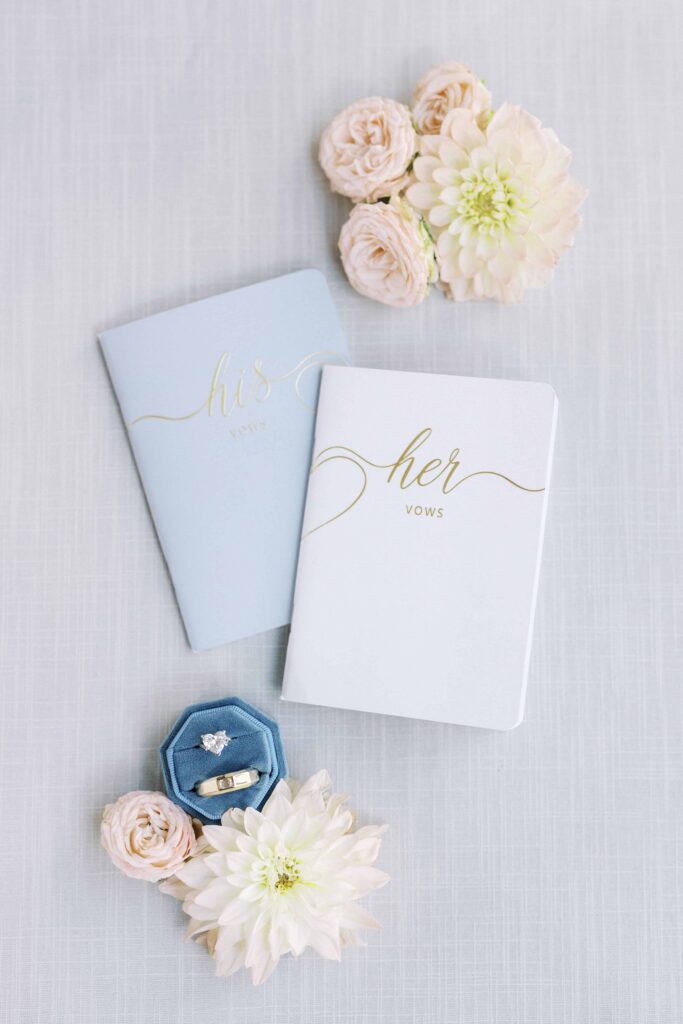 vow books and rings flatlay with pastel florals for a Hotel Crescent Court wedding