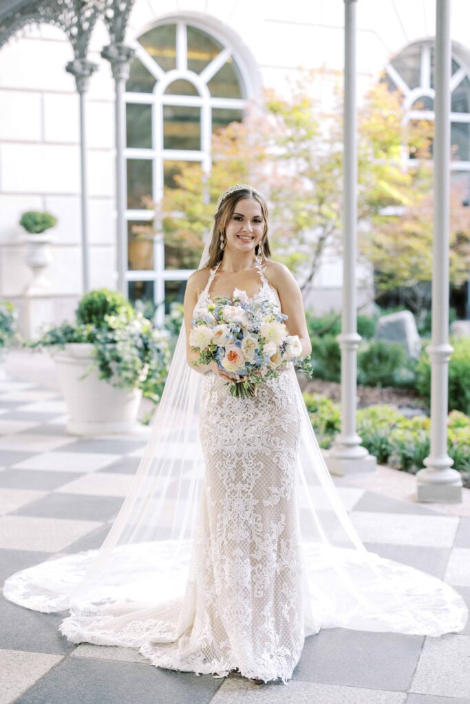 bride posing in the courtyard at her Hotel Crescent Court wedding