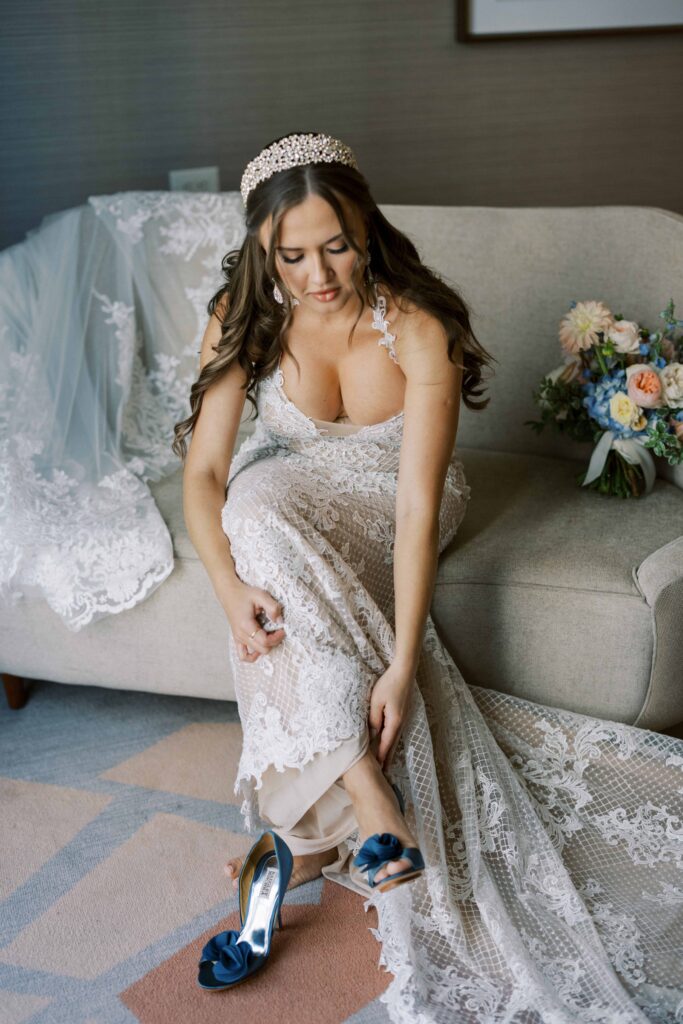 bride puttin on her shoes at her Hotel Crescent Court wedding