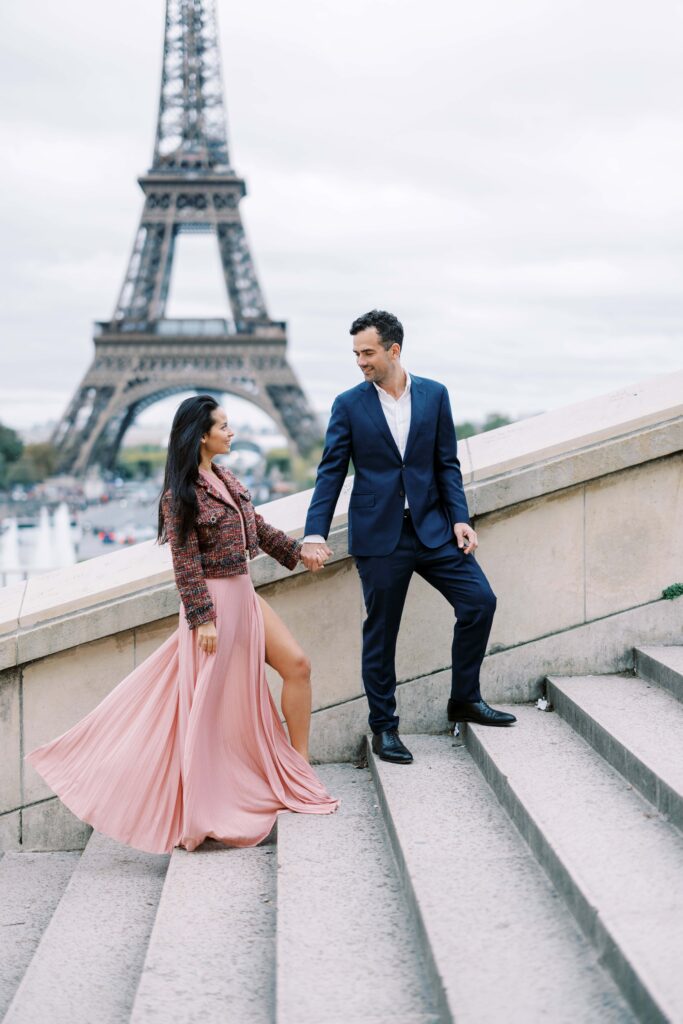 Couple going up the stairs of the trocadéro during their Paris engagement session