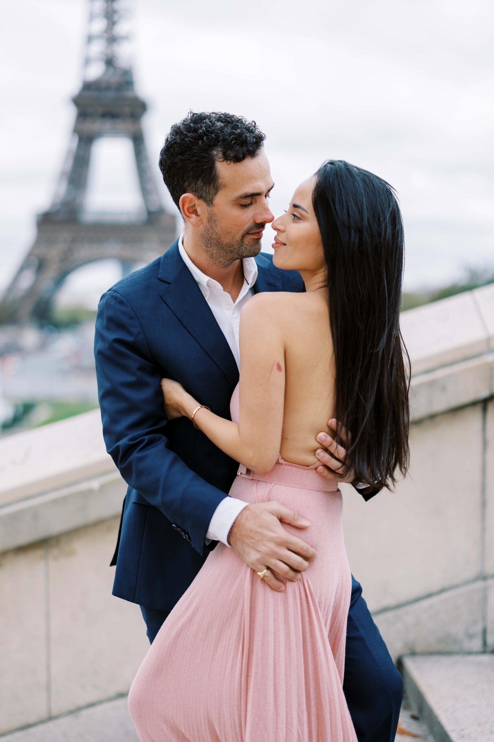 Couple standing on the stairs of the Trocadéro during their Paris engagement session