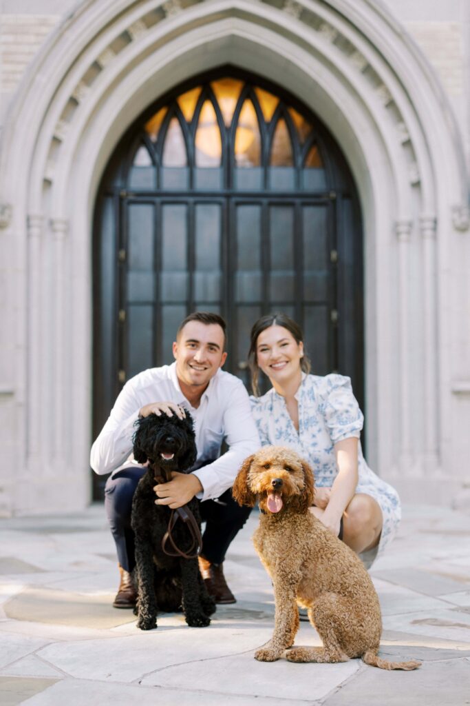 sam and spencer kneeling down with their puppies for their Engagement Session at HPUMC in Dallas