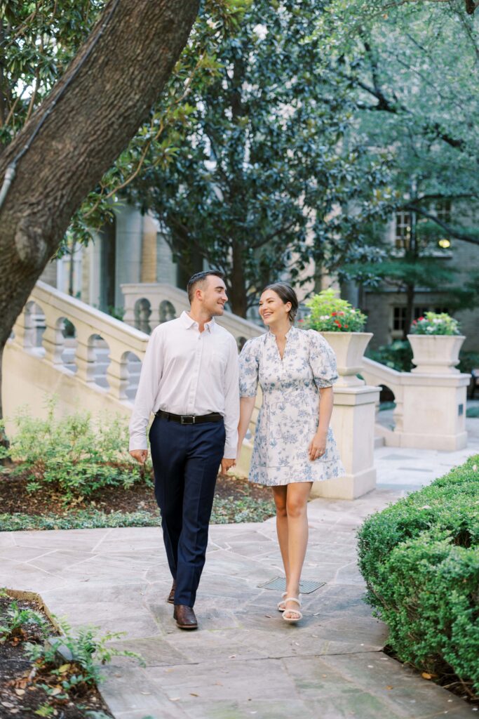 couple walking in the courtyard during their Engagement Session at HPUMC in Dallas