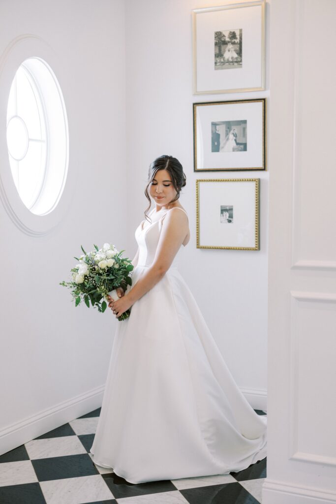 bride standing in the chapel of The Nest at Ruth Farms holding her bouquet