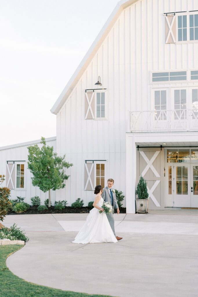 bride and groom walking in front of The Nest at Ruth Farms