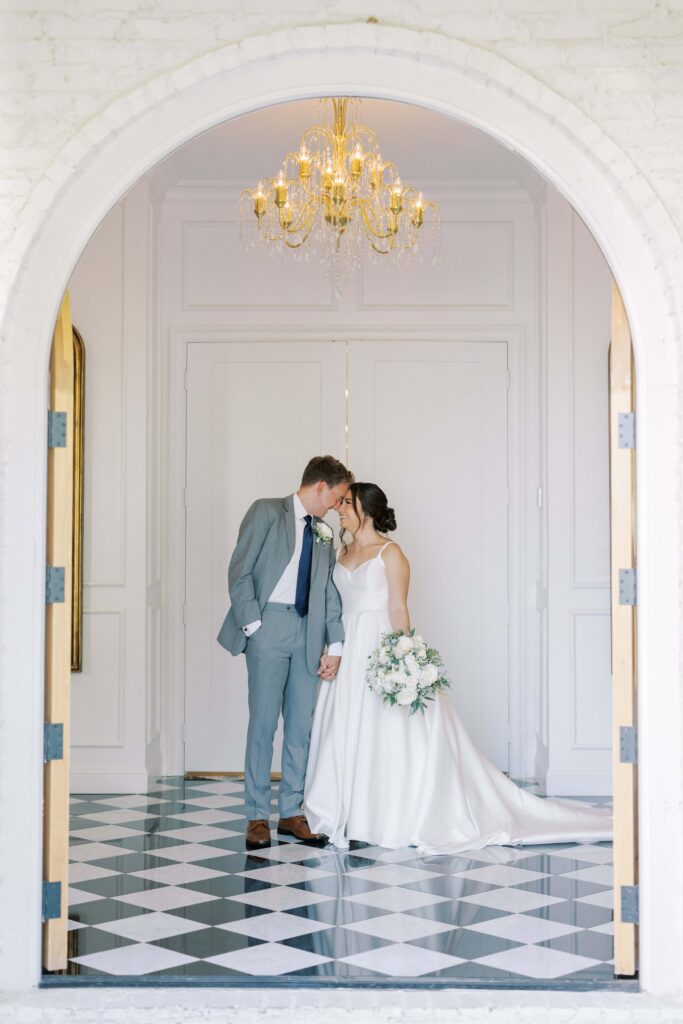 bride and groom forehead to forehead in the chapel at The Nest at Ruth Farms