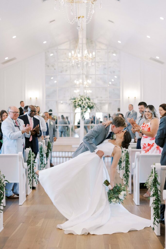 groom dipping the bride down after being pronounced man and wife at The Nest at Ruth Farms