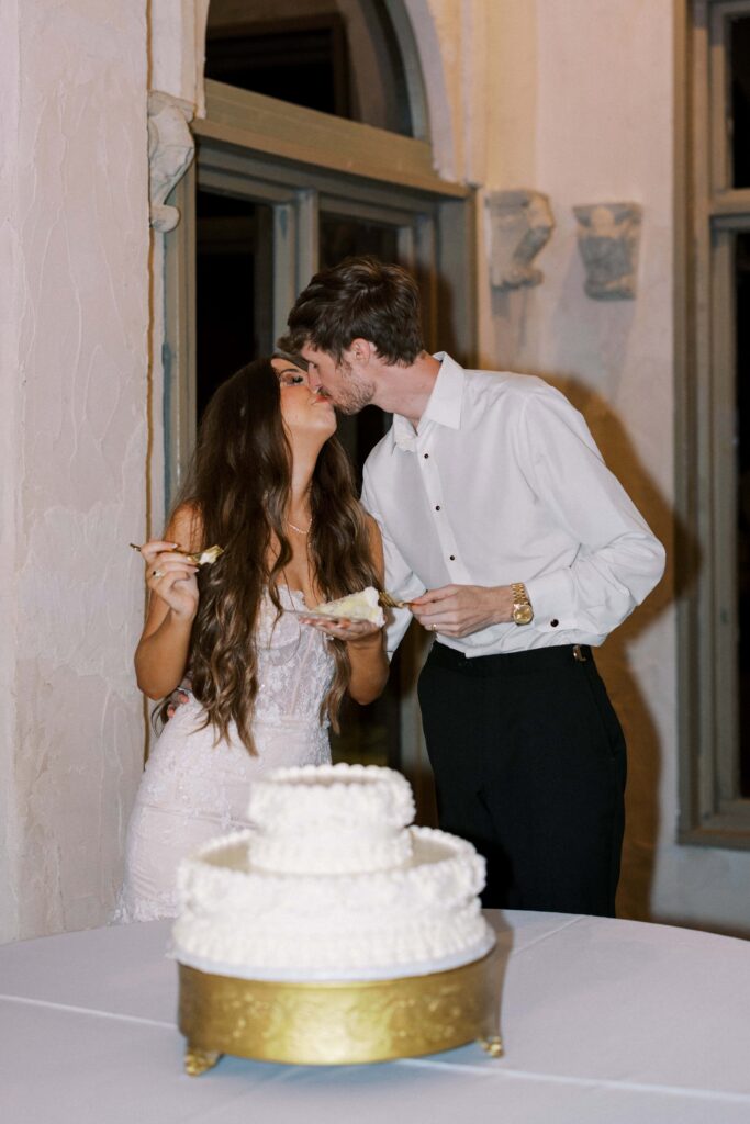 bride and groom kissing after eating their cake during their Intimate Wedding at Villa Antonia near Austin