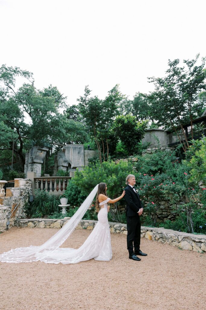 bride having her first look with her father in law in the garden at their Intimate Wedding at Villa Antonia near Austin