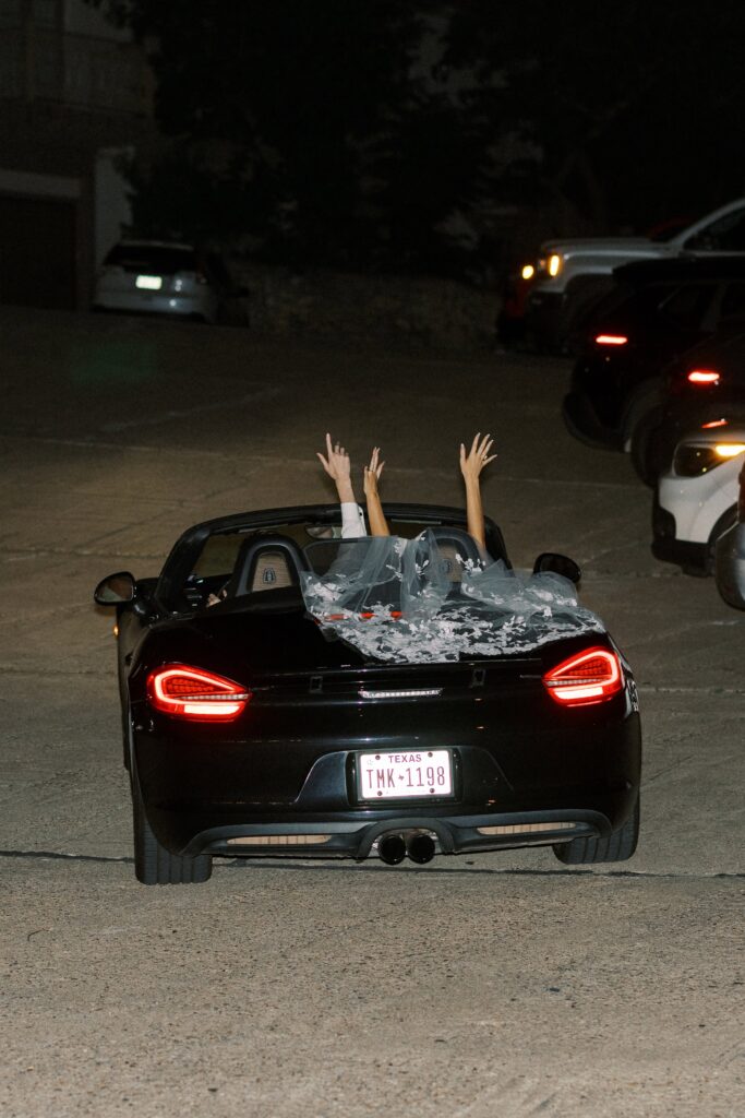 couple exiting in a ferrari after their Intimate Wedding at Villa Antonia near Austin