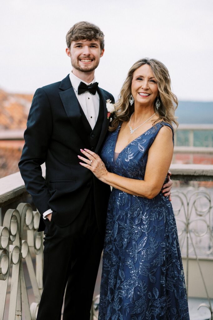 groom with his mother in a sequin blue dress posing at his Intimate Wedding at Villa Antonia near Austin