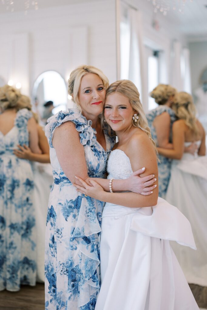 bride and her mom hugging in the bridal suite at the Wedding at Chandelier Farms