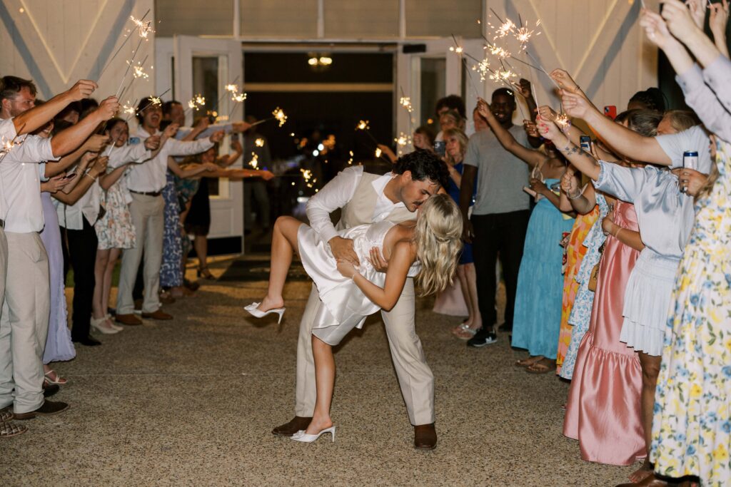 groom dipping and kissing the bride at their Wedding at Chandelier Farms