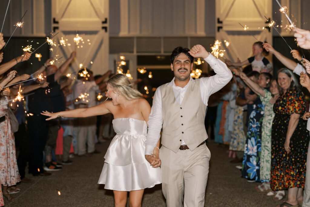 bride and groom exiting and waving at their guests at their Wedding at Chandelier Farms 