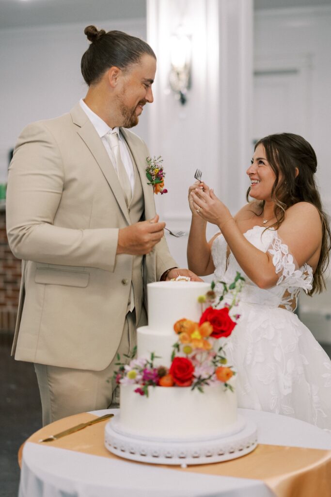 bride and groom eating their wedding cake at The Springs Event Venue Weatherford