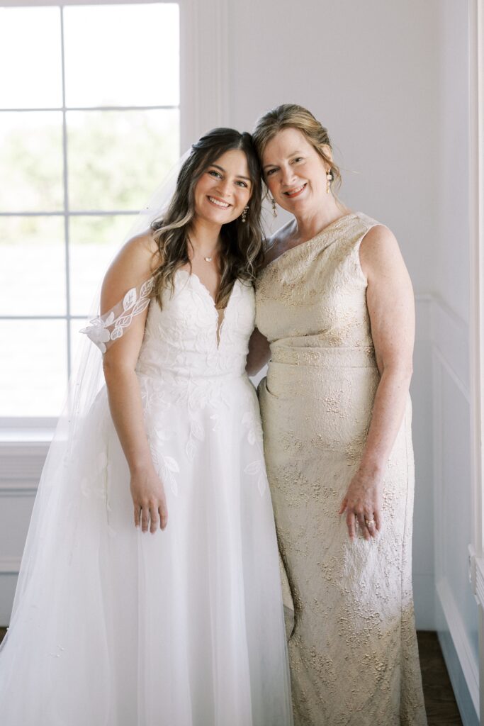 bride and her mom temple to temple looking at the camera at The Springs Event Venue Weatherford