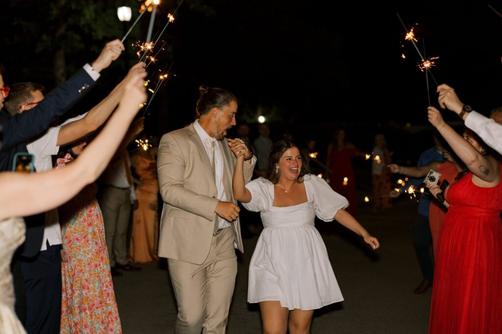 bride and groom exiting their wedding underneath sparklers at The Springs Event Venue Weatherford 