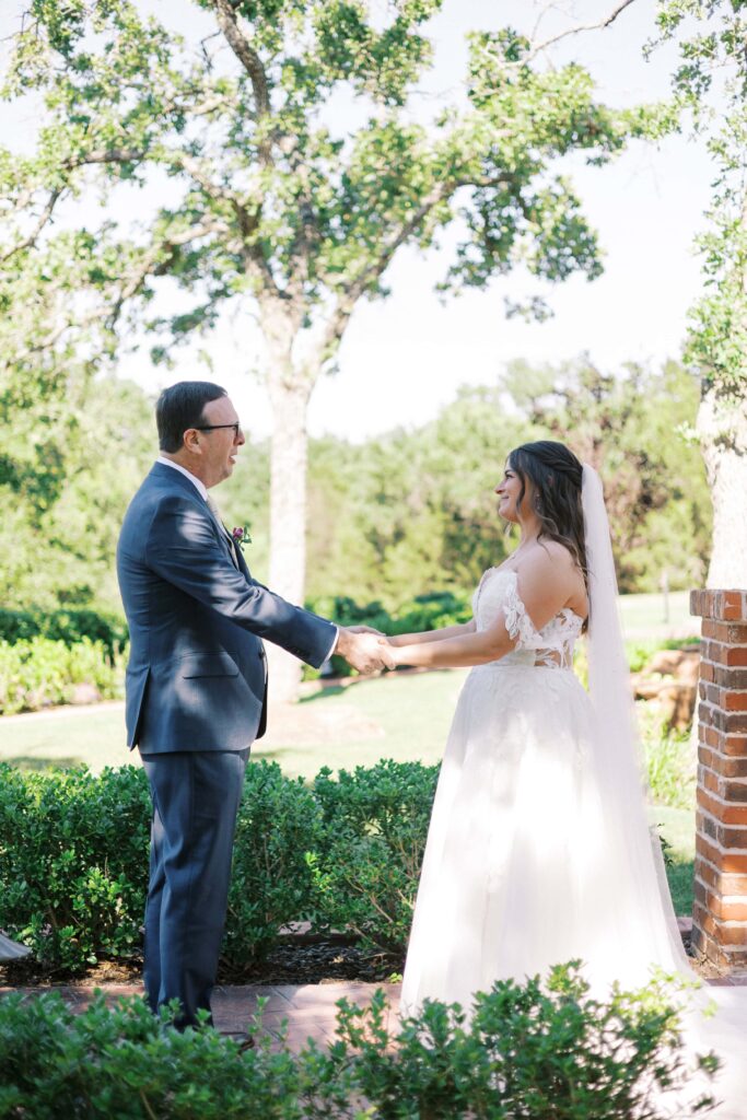 bride and her father holding hands in the garden at The Springs Event Venue Weatherford 