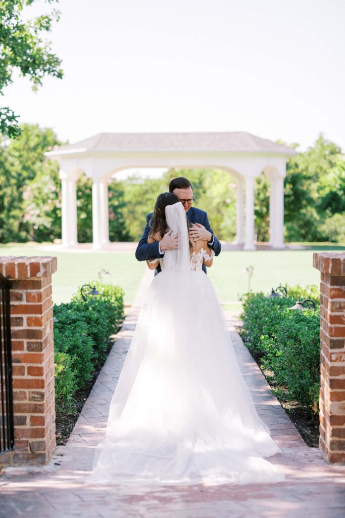 father hugging his daughter in the garden of The Springs Event Venue Weatherford