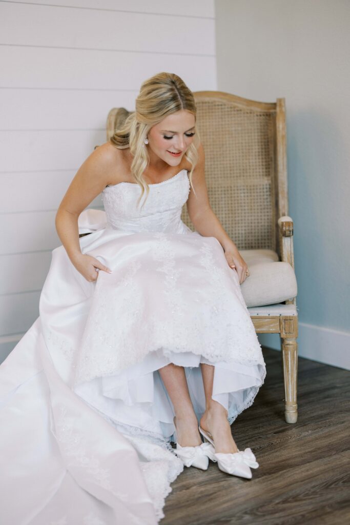 bride putting on her shoes for the Wedding at Chandelier Farms