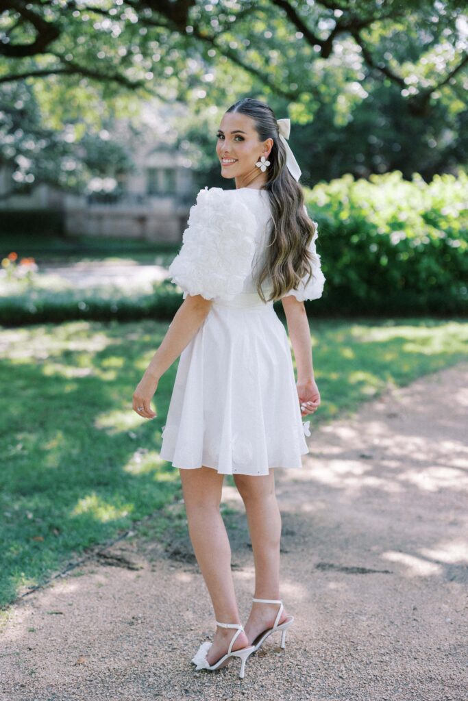 bride smiling at the calera in her white dress during her Engagement Session at Flippen Park