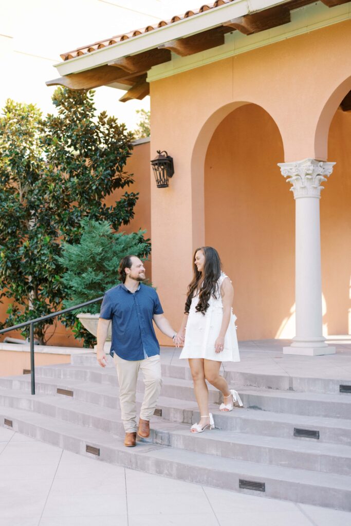 bride and groom walking down the stairs at the Rosewood Mansion in Dallas