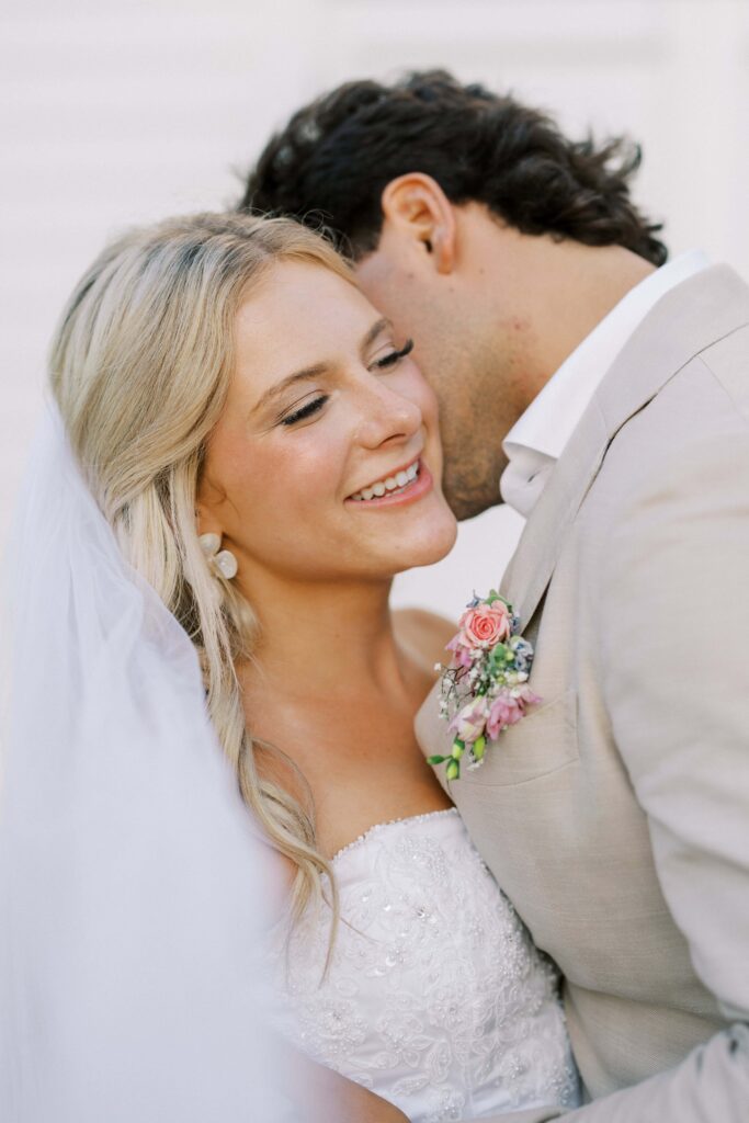 groom whispering in bride's ear during their Wedding at Chandelier Farms