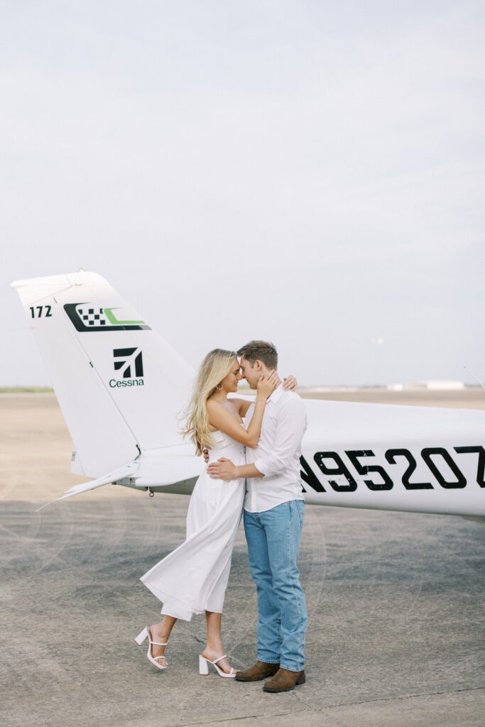 couple forehead to forehead for their Airplane Engagement Session in Dallas-Fort Worth