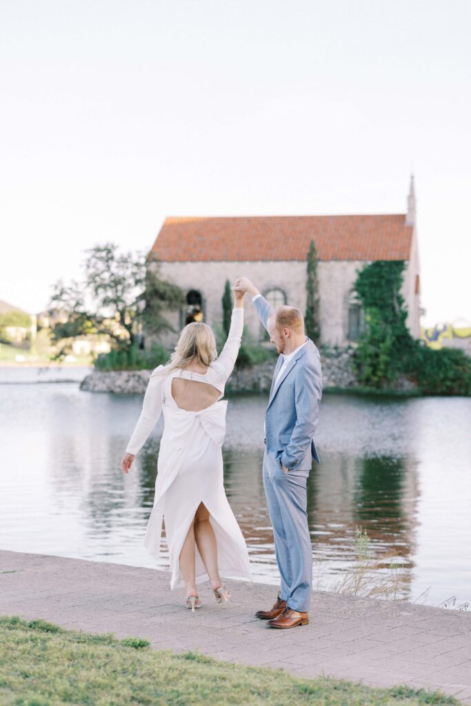 groom twirling the bride at their Adriatica Village Engagement session